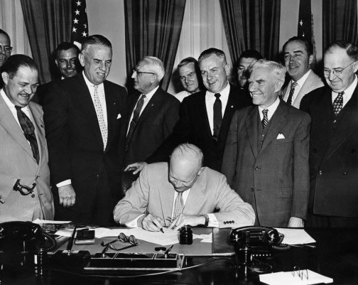 President Dwight D. Eisenhower signs HR7786, changing Armistice Day to Veterans Day, June 1, 1954.