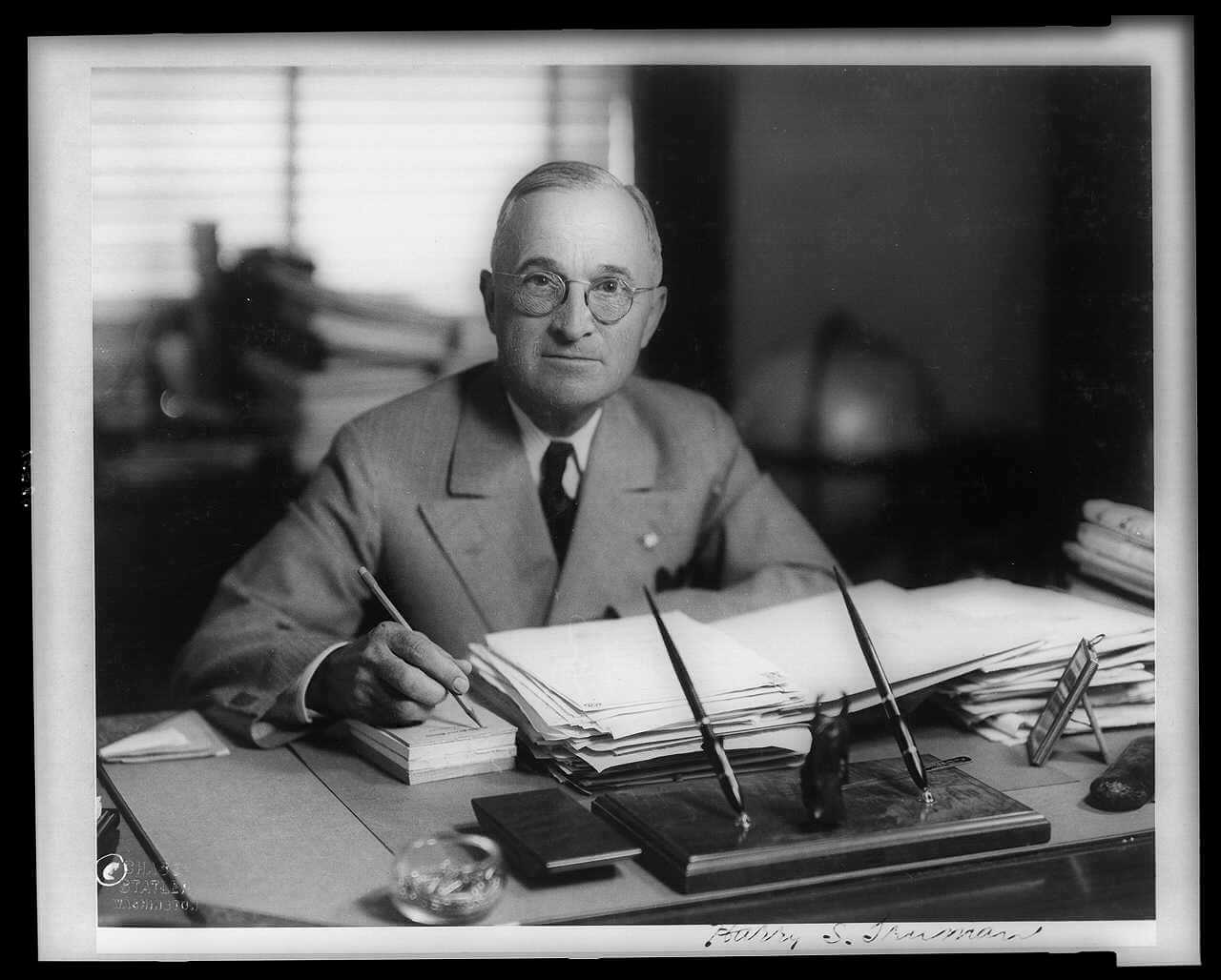 President Harry Truman as has signs paperwork
