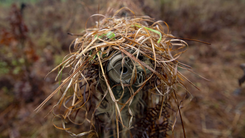 A view of a sniper’s weapon looking down the barrel.