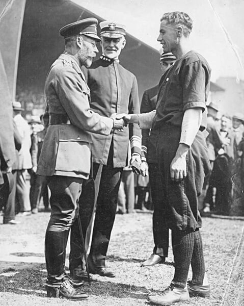 King George shaking hands with soldier baseball player