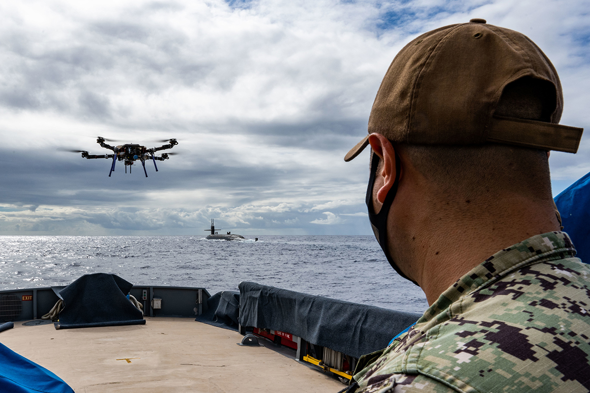 Electronic technician piloting an unmanned aerial vehicle.