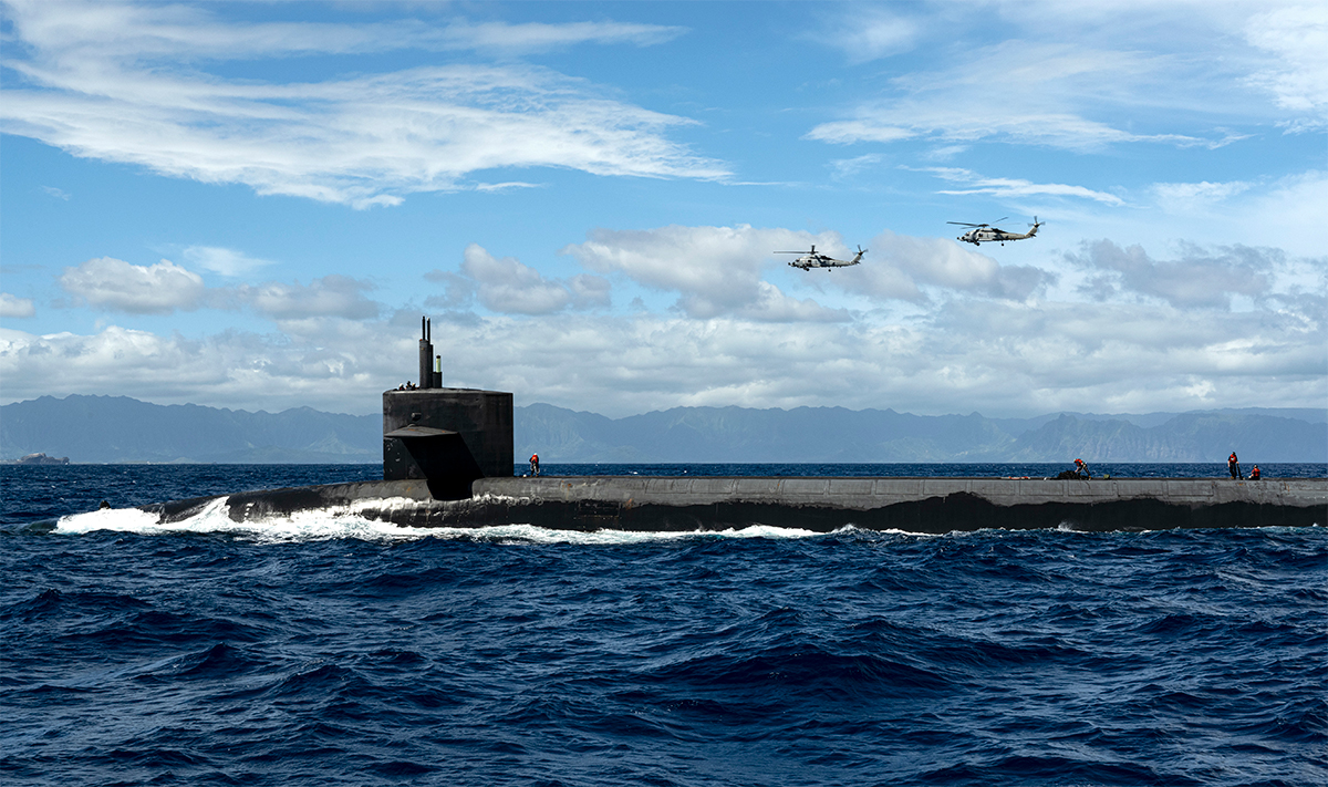 Submarine USS Henry M. Jackson with two seahawks flying above.