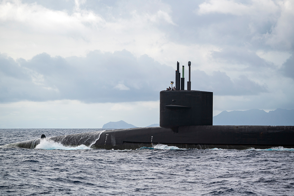 The Ohio-class ballistic-missile submarine USS Henry M. Jackson (SSBN 730) gets in position to receive a payload of supplies from an MV-22B Osprey.