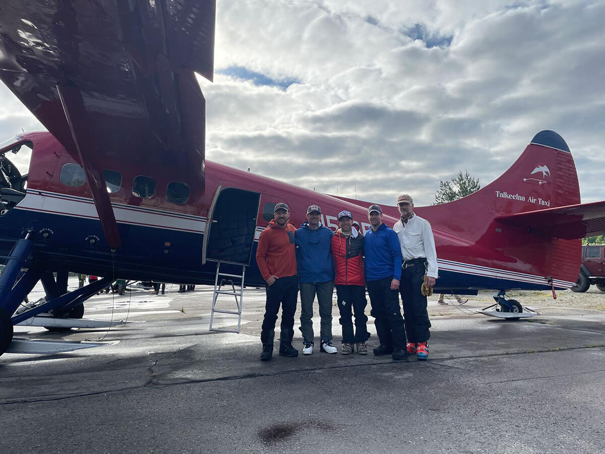 team in front of plane