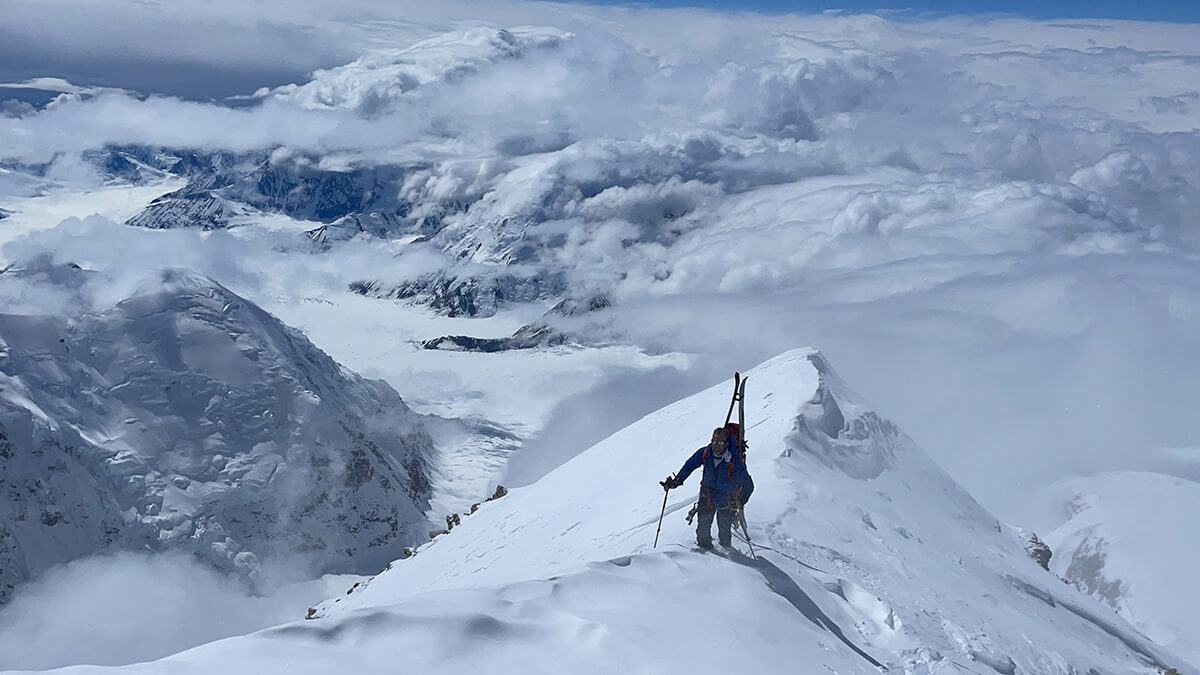 team member on mountain top