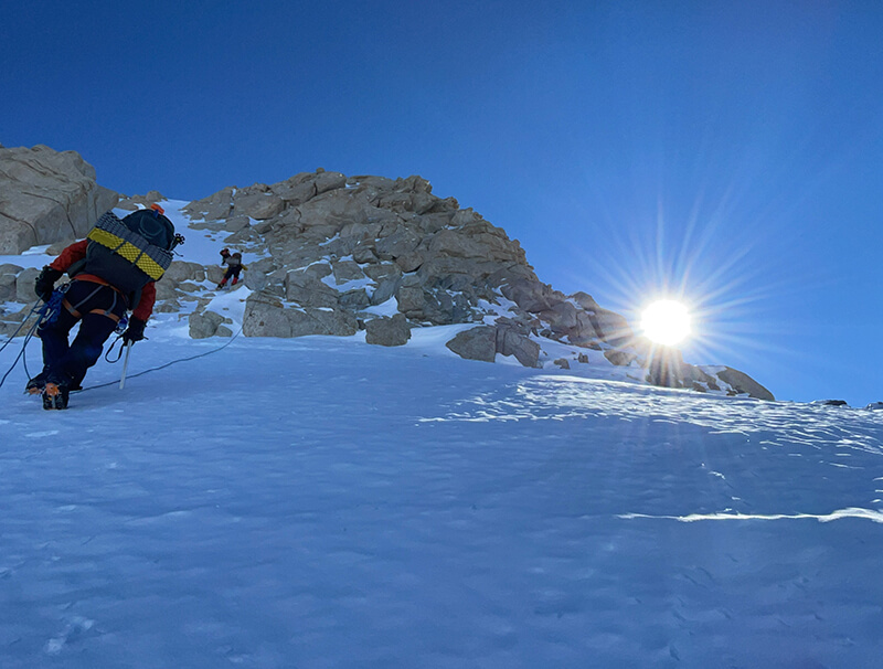 team member climbing mountain with sunrise thumbnail