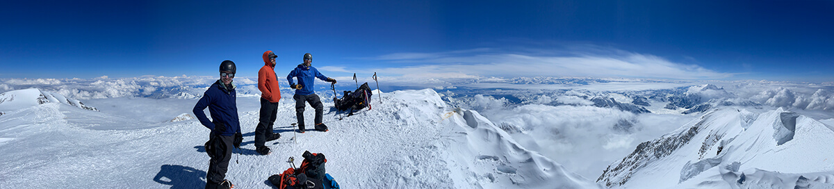 team members on mountain with their equipment