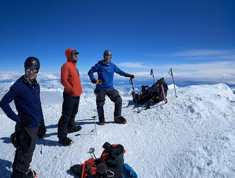 team members on mountain with their equipment thumbnail