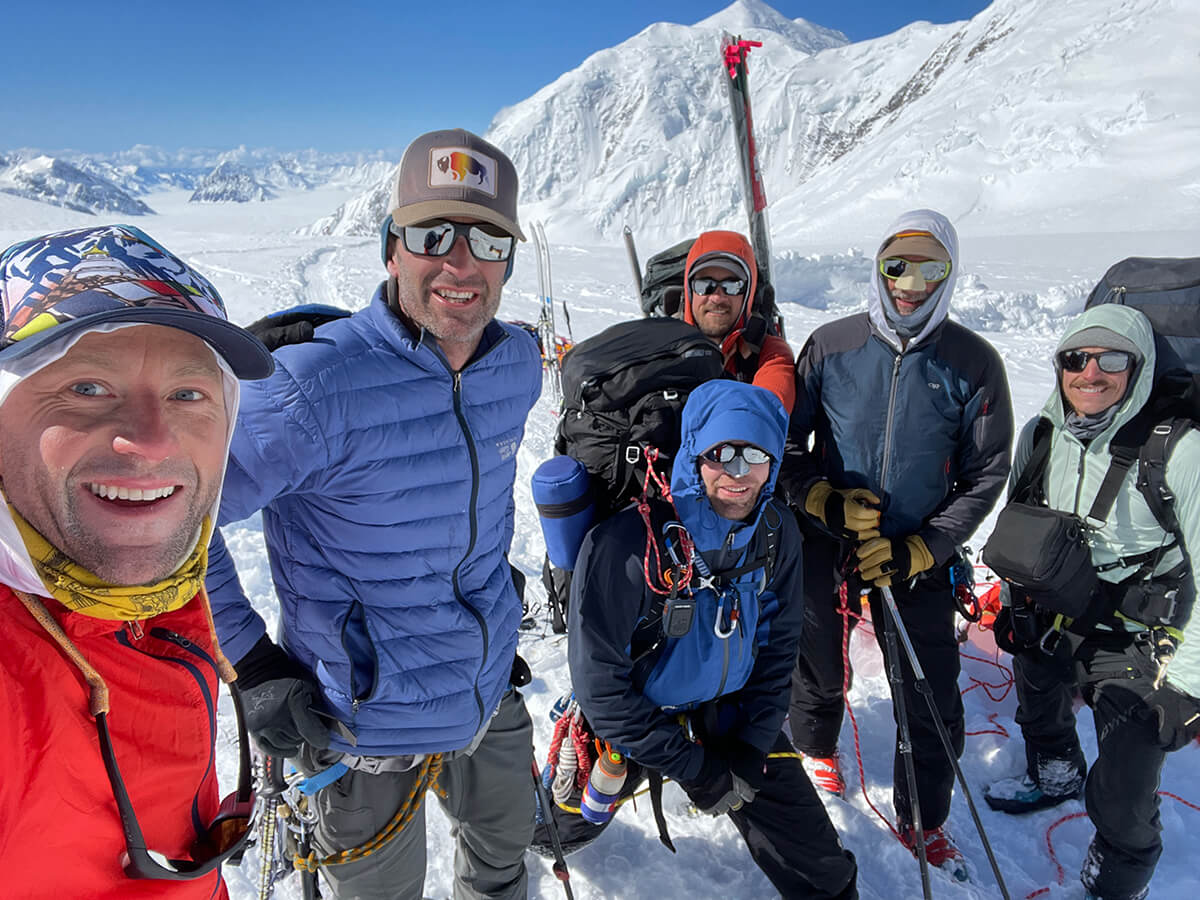 team posing on the mountain