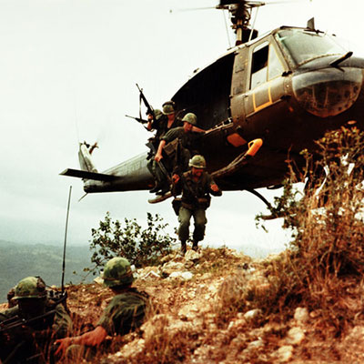 Soldiers jumping out of hellicopter during Vietnam War