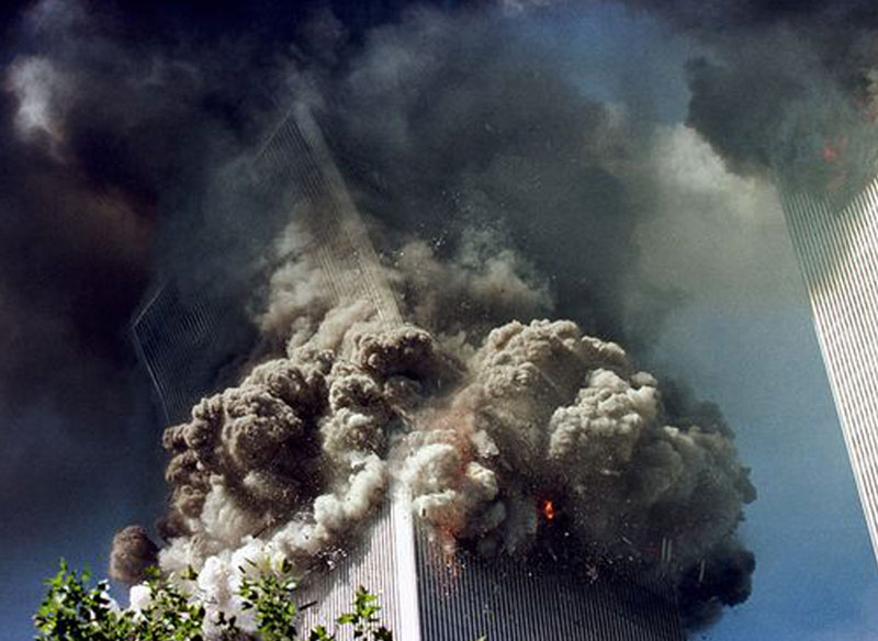 A large pillow of smoke explodes as a World Trade Center tower topples.