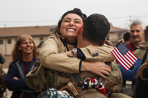 Spouse and soldier hugging after returning home.