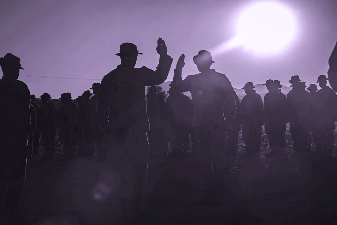 A Marine Corps Cpl. recites the oath of enlistment during his reenlistment ceremony.